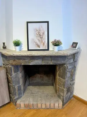 a stone fireplace with two potted plants on it at casa en Palau in Palau-Solità i Plegamans