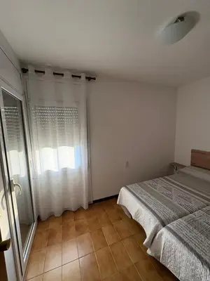 a bedroom with a bed and a window at casa en Palau in Palau-Solità i Plegamans