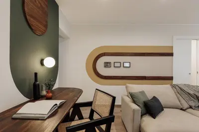 a living room with a television and a chair at Balat - 2 bedrooms and terrace in Eixample Dreta in Barcelona