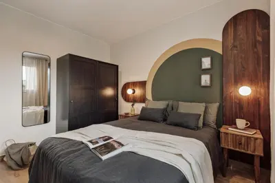 a bedroom with a bed with an arch above it at Balat - 2 bedrooms and terrace in Eixample Dreta in Barcelona