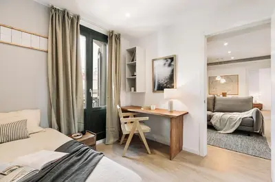 a living room with a couch and a table at Agropoli - 2 bedrooms and terrace in Ciutat Vella in Barcelona
