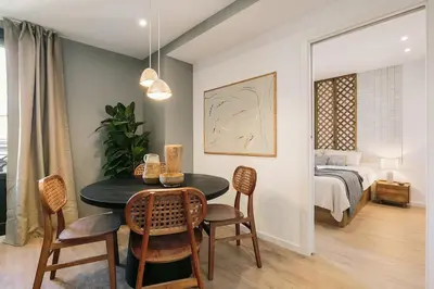 a living room with a couch and a bedroom at Agropoli - 2 bedrooms and terrace in Ciutat Vella in Barcelona
