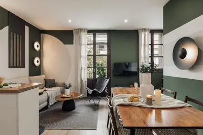 a kitchen and living room with green and white walls at Cinar - 2 bedrooms and balcony in Sant Antoni in Barcelona