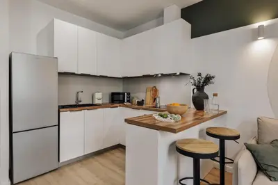a dining room with green walls and a table at Cinar - 2 bedrooms and balcony in Sant Antoni in Barcelona