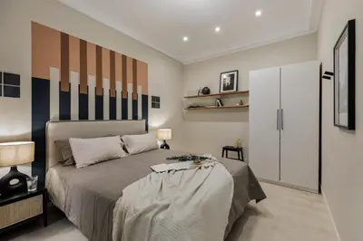 a bedroom with a desk and a mirror on the wall at Cember - 3 bedrooms and patio in Sant Gervasi in Barcelona