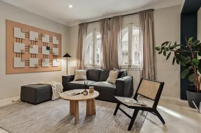 a dining room with a wooden table and chairs at Cember - 3 bedrooms and patio in Sant Gervasi in Barcelona