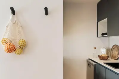 a kitchen and dining room with a table and chairs at Orosi - 2 bedrooms and balcony in Poble Sec in Barcelona