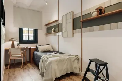 a bedroom with a bed and a desk in a room at Orosi - 2 bedrooms and balcony in Poble Sec in Barcelona