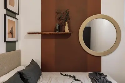 a bedroom with a large bed with a green headboard at Reis - 3 bedrooms and balcony in Vila de Gràcia in Barcelona