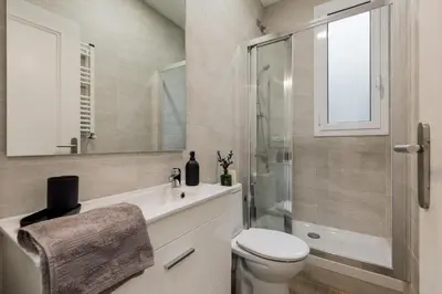 a bedroom with green and white striped walls and a bed at Reis - 3 bedrooms and balcony in Vila de Gràcia in Barcelona