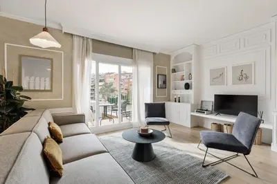 a white bedroom with a bed and a chair at Serralada - 4 bedrooms and terrace in Sant Gervasi in Barcelona