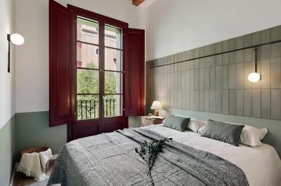 a living room with a table and chairs at Estiu - 2 bedrooms and balcony in Sant Antoni in Barcelona