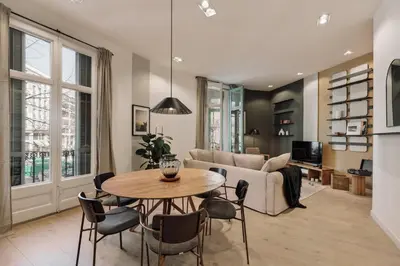 a bedroom with a bed and a desk with a computer at Hidiv - 3 bedrooms and terrace in Eixample Dreta in Barcelona