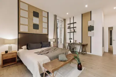 a kitchen with white cabinets and a counter with chairs at Hidiv - 3 bedrooms and terrace in Eixample Dreta in Barcelona