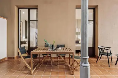 a dining room with a wooden table and chairs at Hidiv - 3 bedrooms and terrace in Eixample Dreta in Barcelona