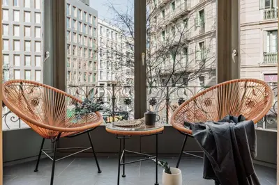 a living room with a couch and a table at Hidiv - 3 bedrooms and terrace in Eixample Dreta in Barcelona