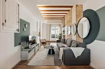 a bedroom with a bed with a teddy bear on it at Lygos - 2 bedrooms and terrace in Eixample Esquerra in Barcelona