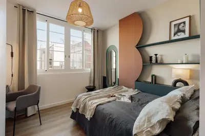 a living room with a couch and a brick wall at Lygos - 2 bedrooms and terrace in Eixample Esquerra in Barcelona