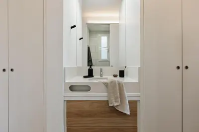a bedroom with a large bed and a chair at Lygos - 2 bedrooms and terrace in Eixample Esquerra in Barcelona