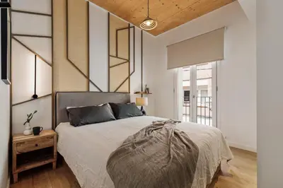 a kitchen and dining room with a wooden table and chairs at Arenal - 3 bedrooms and terrace in Sarrià in Barcelona