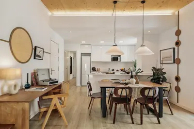 a living room with a table and chairs and a couch at Arenal - 3 bedrooms and terrace in Sarrià in Barcelona
