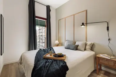 a bedroom with a large bed with a tray on it at Blava - 2 bedrooms in Sant Antoni in Barcelona