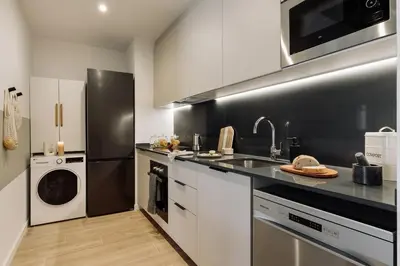 a living room with a couch and a table at Blava - 2 bedrooms in Sant Antoni in Barcelona