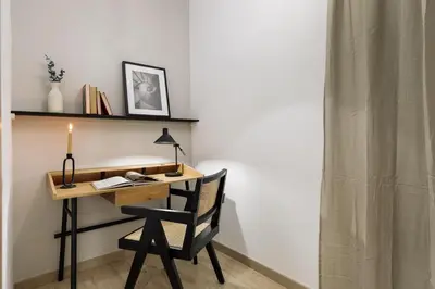 a living room with a couch and a tv on a wall at Llaberia - 2 bedrooms in Sant Gervasy in Barcelona