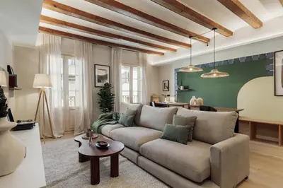 a living room with a couch and a table at Izmit - 2 bedrooms and balcony in Sant Pere in Barcelona