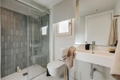 a bedroom with a green accent wall with shelves at Izmit - 2 bedrooms and balcony in Sant Pere in Barcelona