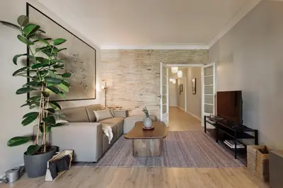 a kitchen with white appliances and a brick wall at Morell - 3 bedroom and office in Eixample Esquerra in Barcelona
