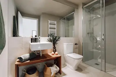 a bedroom with a bed with a camera on it at Algar - 1 bedroom and balcony in Eixample Esquerra in Barcelona