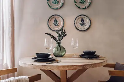 a table and chairs on a balcony with a clock tower at Algar - 1 bedroom and balcony in Eixample Esquerra in Barcelona