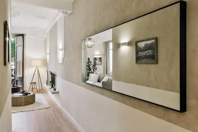 a bed with two lamps and a book on it at Baia - Studio and balcony in Eixample Esquerra in Barcelona