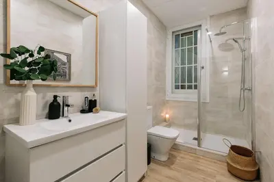 a room with a desk with a chair and a window at Baia - Studio and balcony in Eixample Esquerra in Barcelona