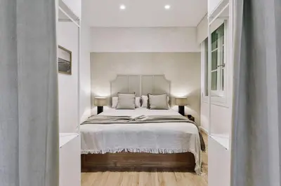 a living room with a couch and a fireplace at Baia - Studio and balcony in Eixample Esquerra in Barcelona