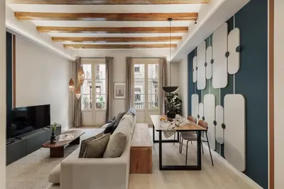 a living room with a couch and a table at Cesme - 2 bedrooms and balcony in Sant Pere in Barcelona