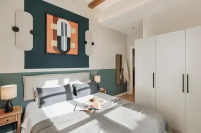 a dining room with blue walls and a table with a lamp at Cesme - 2 bedrooms and balcony in Sant Pere in Barcelona