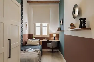 a small bedroom with a bed and a desk at Cesme - 2 bedrooms and balcony in Sant Pere in Barcelona