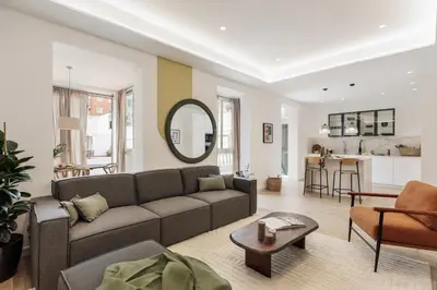 a living room with a couch and a table at Sishane - 3 bedrooms and terrace in Eixample Esquerra in Barcelona