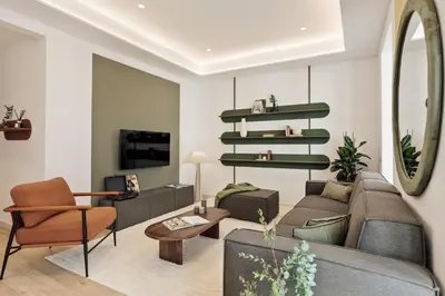 a living room with a couch and a table at Sishane - 3 bedrooms and terrace in Eixample Esquerra in Barcelona