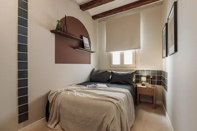 a bedroom with two beds and a mirror at Ipek - 2 bedrooms and balcony in Sant Pere in Barcelona