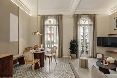 a living room with a couch and a table at Niria - 2 bedrooms and balcony in Eixample Esquerra in Barcelona