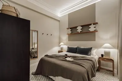 a bed with a book and a plate of fruit on it at Niria - 2 bedrooms and balcony in Eixample Esquerra in Barcelona