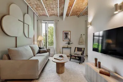 a living room with a couch and a table at Nal - 2 bedrooms, office and balcony in Eixample Dreta in Barcelona