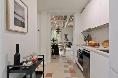 a kitchen with white cabinets and a stove at Nal - 2 bedrooms, office and balcony in Eixample Dreta in Barcelona