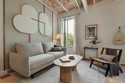 a bathroom with a sink and a toilet and a mirror at Nal - 2 bedrooms, office and balcony in Eixample Dreta in Barcelona