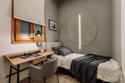 a kitchen with white cabinets and a wooden table at Kusku - 3 bedrooms and balcony in Eixample Dreta in Barcelona