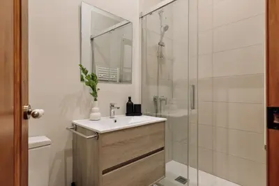 a bedroom with a bed with a book on it at Kusku - 3 bedrooms and balcony in Eixample Dreta in Barcelona
