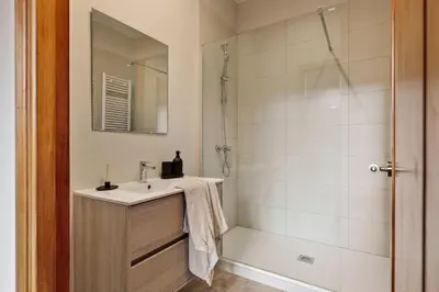 a living room with a bed and a chair at Kusku - 3 bedrooms and balcony in Eixample Dreta in Barcelona